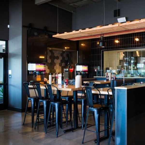 Black Edison Distressed stools throughout the bar area accentuate the industrial look.